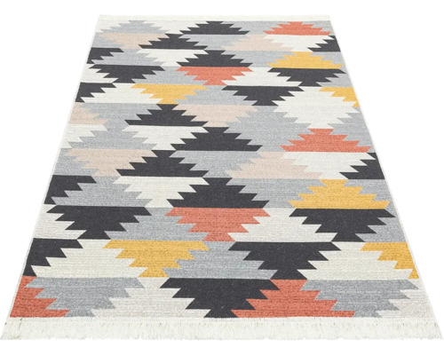 Koberec Kilim s geometrickým klikatým vzorem a krátkými třásněmi.