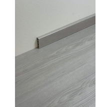 Podlahová lišta imitující dřevo namontovaná na zdi