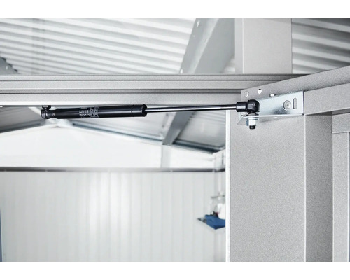 Detailní záběr plynové vzpěry na kovovém rámu