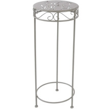 Kovový ozdobný sloup s rostlinným vzorem na desce stolu