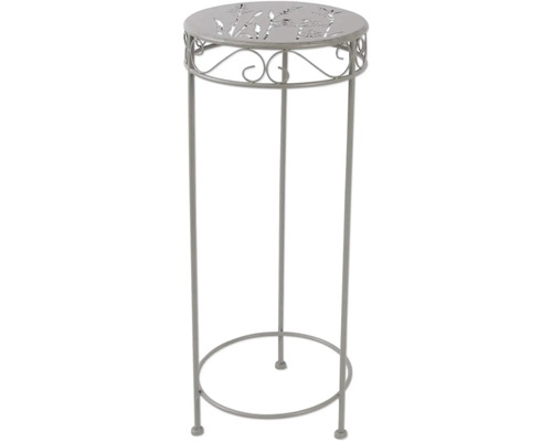 Kovový ozdobný sloup s rostlinným vzorem na desce stolu