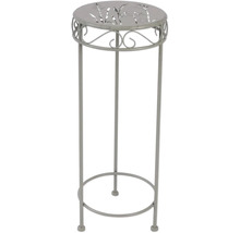 Květinový stolek z kovu se vzorem na desce stolu