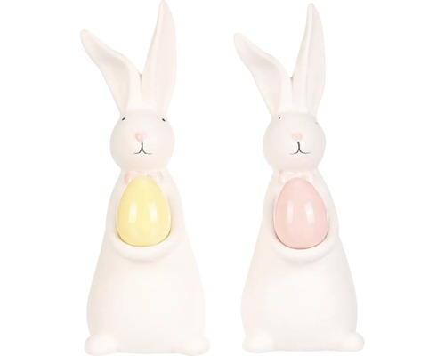 Dvě bílé velikonoční figurky zajíčků s vejcem