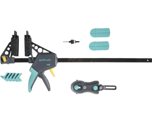 Jednoruční svěrka Wolfcraft se sadou příslušenství obsahující vrták, ochranné krytky a adaptéry.