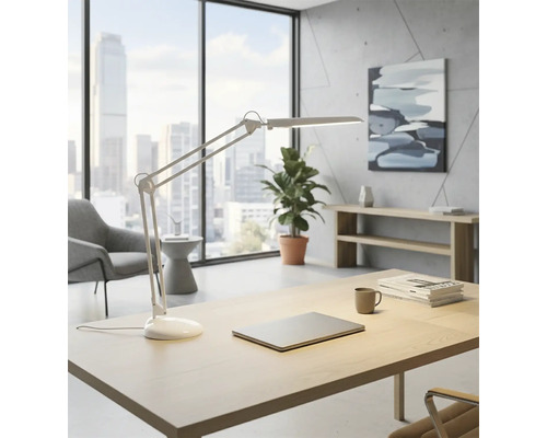 Světlá kancelář s psacím stolem, stolní lampou, notebookem, rostlinou a oknem s výhledem na město