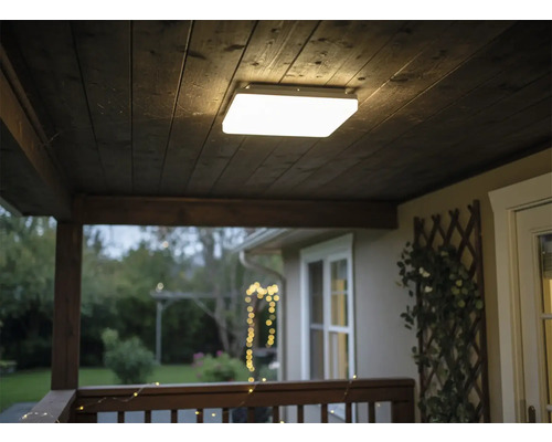 Čtvercové stropní svítidlo na dřevěném stropě na verandě.