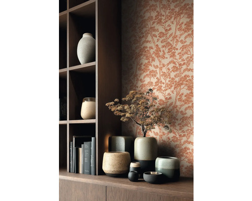 Vliesová tapeta se vzorem borovic v rezavém vzhledu za tmavou dřevěnou policí s keramickými vázami a knihami.