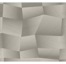 Šedá vliesová tapeta s geometrickým trojrozměrným vzorem nepravidelných mnohoúhelníků a jemnou liniovou strukturou.