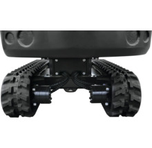 Podvozek minibagru s černými gumovými pásy a hydraulickým pohonem.