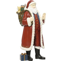 Figurka Santa Clause s pytlem plným dárků na zádech a dárkovým balíčkem u nohou, tradiční vánoční dekorace.