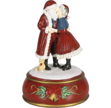 Vánoční hrací skříňka s líbajícím se párem Santa Clause a medvídkem na červeném podstavci s mašlí.