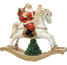 Vánoční figurka Santa Claus na bílém houpacím koni nad vánočním stromkem