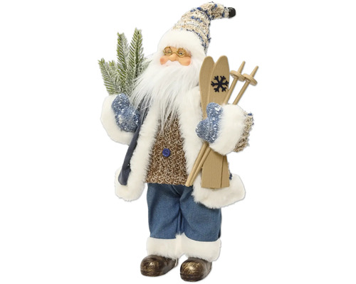 Dekorativní figurka Santa Clause s lyžemi, brýlemi a jedlovou větví, v pleteném svetru, modrém kabátě a kalhotách s bílým kožešinovým lemem.