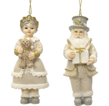 Sada dvou vánočních ozdob, dívka s medvídkem a Santa Claus s dárkem, béžová a zlatá.