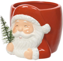 Vánoční keramický květináč ve tvaru Santa Clause s malým vánočním stromkem.