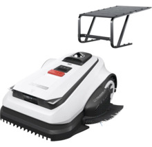 Robotická sekačka s bílým krytem, černými detaily a červeným tlačítkem stop, včetně černé garážové střechy.