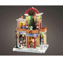 Osvětlený vánoční obchod s hračkami s figurkami, vánočním stromkem, louskáčky a nápisem Merry Christmas pro vánoční vesničky.