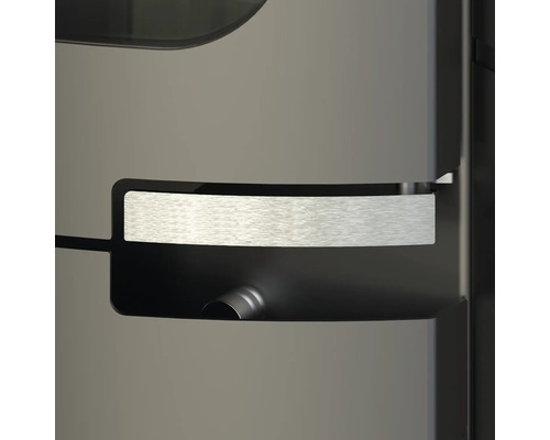 Detailní záběr na moderní rukojeť krbových kamen z kartáčovaného kovu v prohlubni.