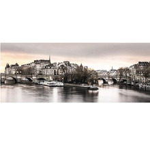 Panoramatický nástěnný obraz Paříže se Seinou, mostem Pont Neuf a historickými budovami za soumraku.