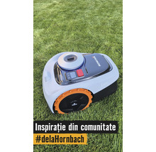 Robotická sekačka Navimow i105 na trávníku s oranžovými koly a ovládacím panelem.