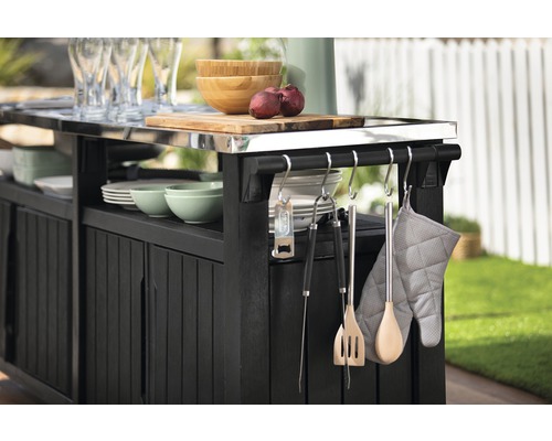 Černá venkovní kuchyně s kuchyňským náčiním, nádobím a krájecí deskou