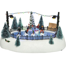Zimní vesnička se scénou s kluzištěm, figurkami a osvětlením jako dekorace