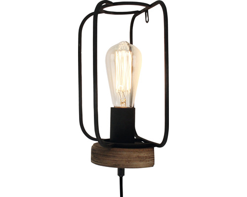 Stolní lampa s kovovým rámem a žárovkou Edison.