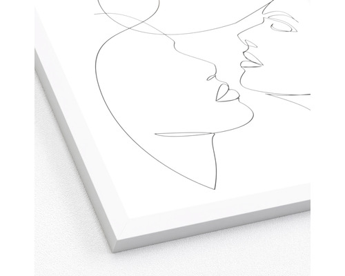 Zarámovaný plakát s liniovou kresbou dvou tváří otočených k sobě