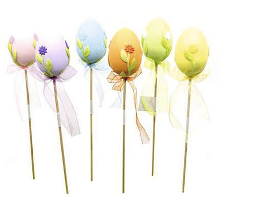 Dekorativní velikonoční vajíčka na tyčkách s květinovými motivy a stuhami.