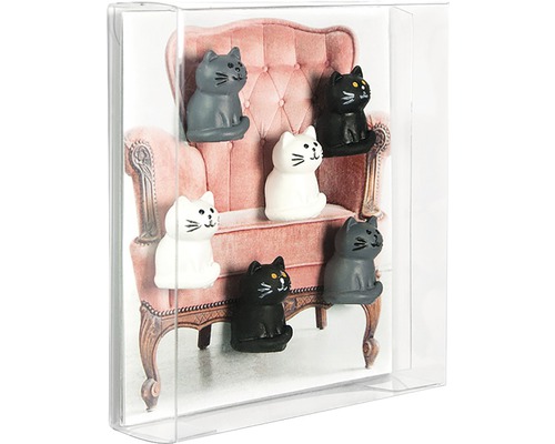 Dekorativní magnety ve tvaru koček před obrázkem židle