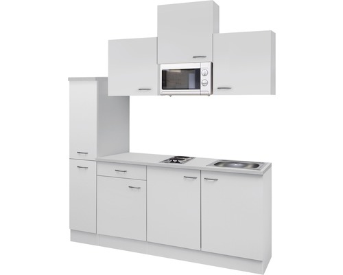 Bílá kuchyňská linka s mikrovlnnou troubou, dřezem a varnou deskou