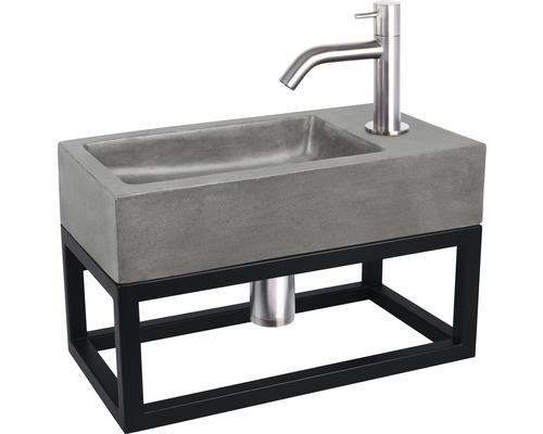 Umyvadlo z betonu s ocelovým rámem a vodovodní baterií