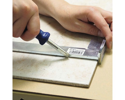 Dlaždice je řezána řezačkou dlaždic.