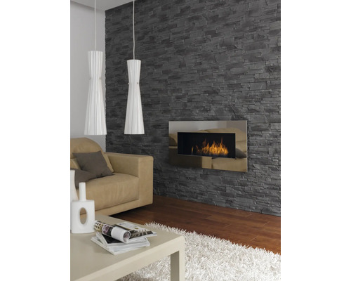 Obývací pokoj s kamennou tapetou, krbem, pohovkou, stolem a dvěma závěsnými světly