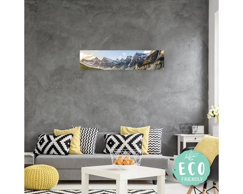 Obývací pokoj s pohovkou, stolem a nástěnnou malbou horské krajiny