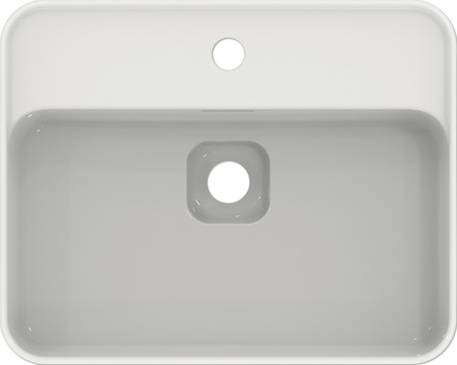 Pohled shora na obdélníkové umyvadlo s otvorem pro kohoutek a přepadem