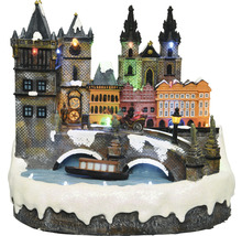 Osvětlené miniaturní zimní město s mostem a lodí jako dekorace