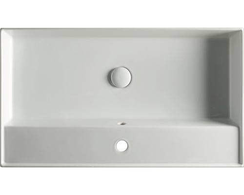 Pohled shora na obdélníkové umyvadlo s otvorem pro kohoutek a přepadem