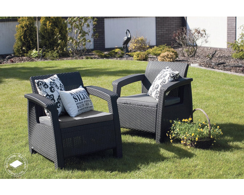 Dvě ratanová křesla s polštáři a dekorací na zahradě