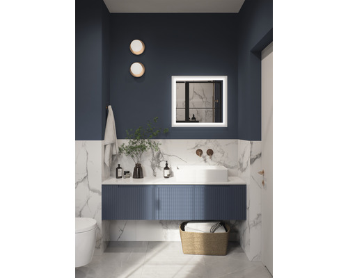 Koupelna s umyvadlem, zrcadlem s osvětlením, ručníkem a dekorací