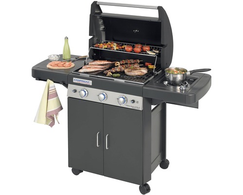 Plynový gril Campingaz s jídlem na grilovací mřížce, včetně bočního hořáku a úložného prostoru