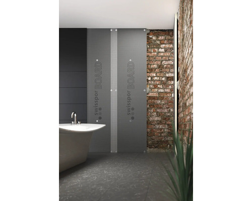 Koupelna s vanou a izolačními deskami Swisspon Board před cihlovou zdí