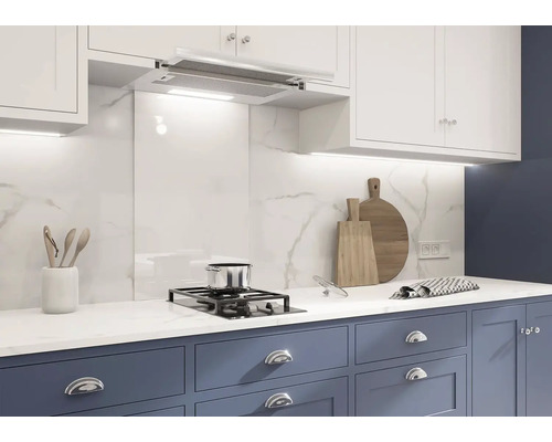 Kuchyňská scéna s bílými mramorovými obklady, digestoří a modrými skříňkami