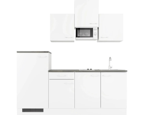 Bílá kuchyňská linka s dřezem, sporákem a mikrovlnnou troubou
