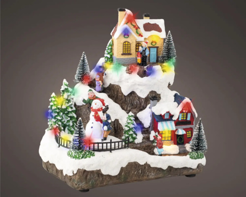 Dekorativní vánoční scéna s domy, stromy, sněhulákem a figurkami
