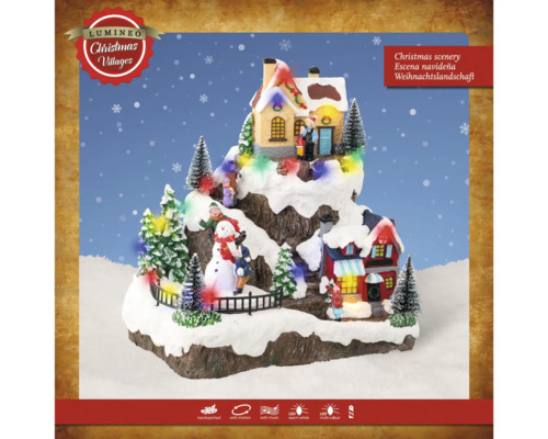 Osvětlená vánoční krajina s domy a figurkami