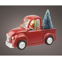 Dekorativní červená sněhová koule ve tvaru náklaďáku s vánočním stromkem a figurkou Santa Clause