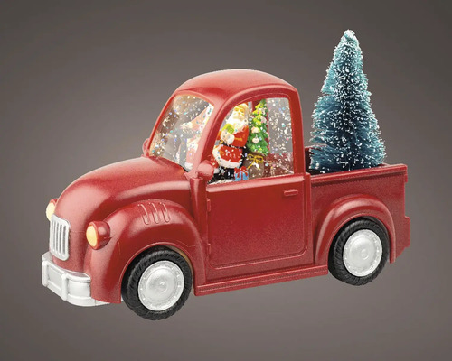 Dekorativní červená sněhová koule ve tvaru náklaďáku s vánočním stromkem a figurkou Santa Clause