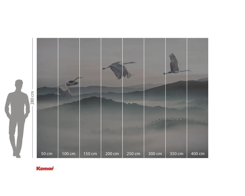 Fototapeta s jeřáby letícími nad hornatou krajinou