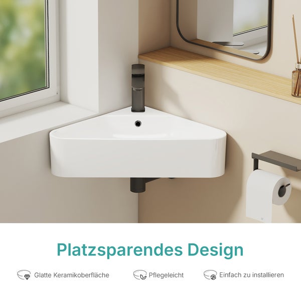 Rohové umyvadlo z keramiky v moderním designu koupelny s prostorově úspornou montáží na stěnu a tmavou baterií.